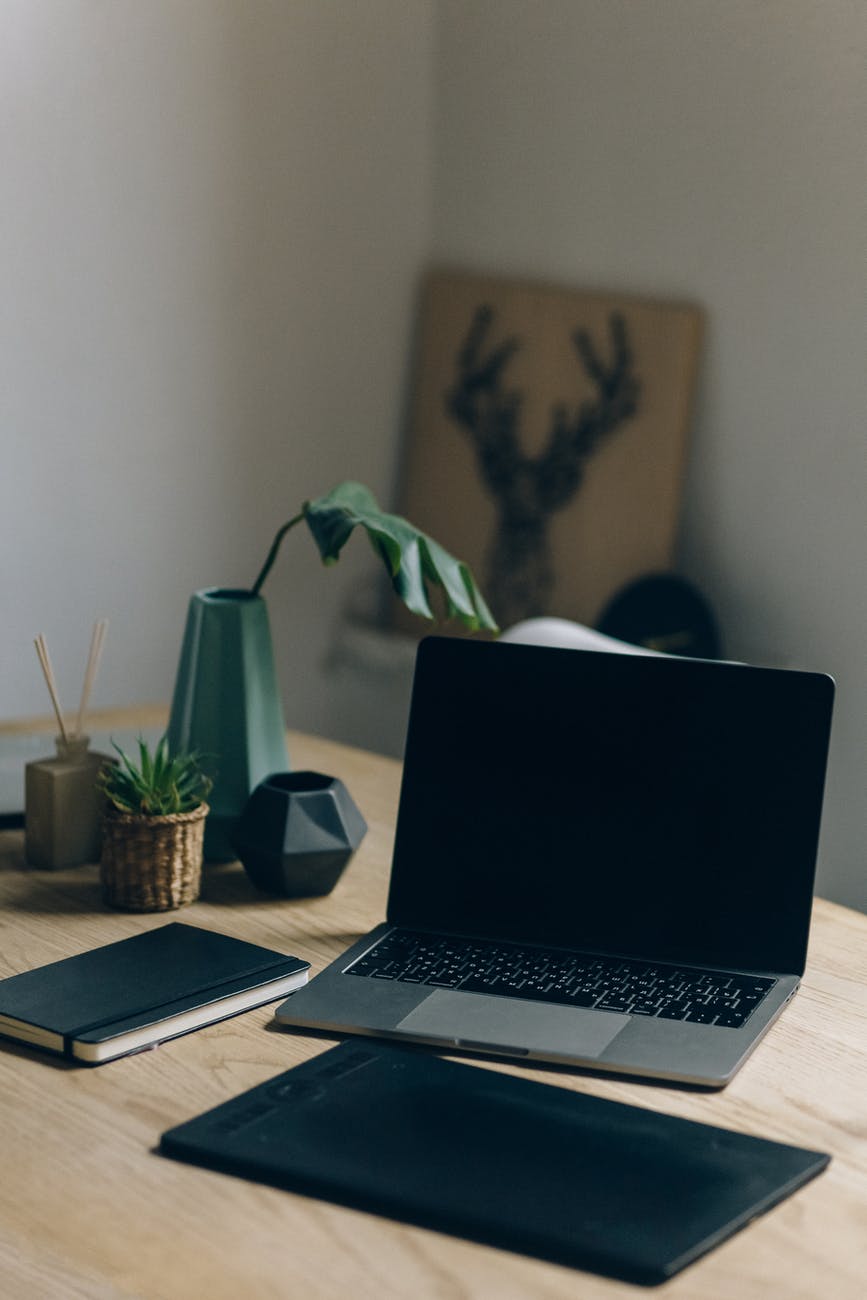 macbook pro on brown wooden table
