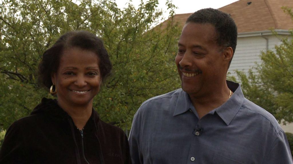 Older African American couple standing outside